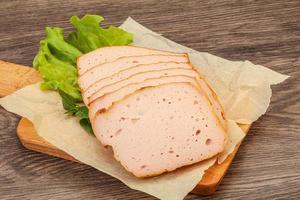 Boiled pork sausage over board photo