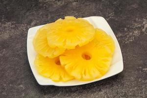 Marinated pineapple rings in the bowl photo