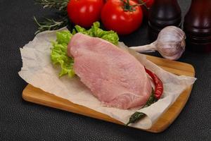 Raw Turkey steak served rosemary photo
