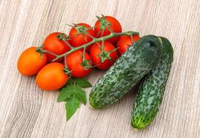 Cucumbers and tomatoes on the branch photo