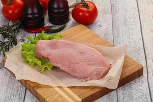 Raw Turkey steak served rosemary photo