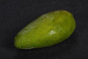 Green tasty mango over wooden background photo