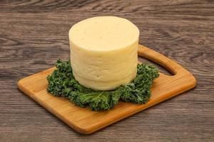 Yellow round dairy soft cheese photo