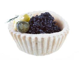 black caviar canape on white background photo