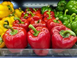 Fresh bell peppers are on the shelf photo