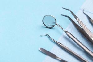 Set of dental instruments on a blue background photo