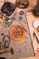 handmade copper wire working tools on the table with accessoires. handicraft people art concept photo