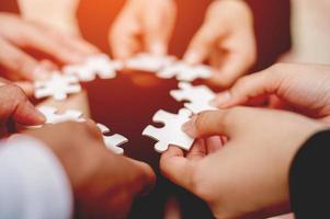 Close-up of businessman with puzzle pieces in office teamwork unity in teamwork The concept of combining strength and power photo