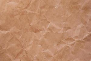 Wrinkled brown paper background. photo