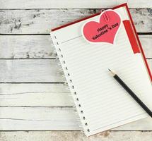 Notebook open with valentine day card photo