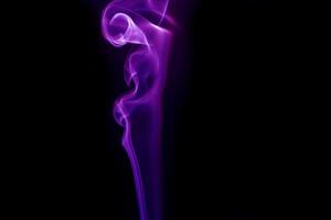 Purple smoke on black background photo