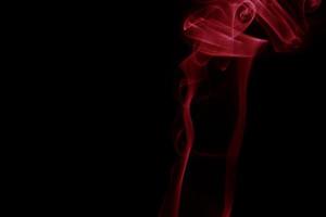 Red smoke on black background photo