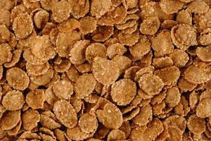 Crispy healthy dry cereal flakes as a background texture photo
