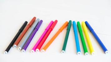 Multicolored felt-tip pens on a white background photo