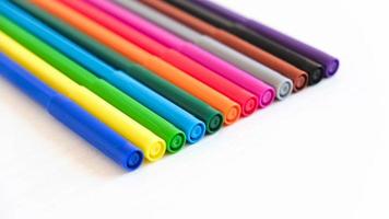 Multicolored felt-tip pens on a white background photo