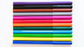 Multicolored felt-tip pens on a white background photo