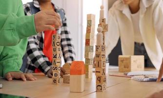 African American teacher and student doing activity playing block wooden for development together with enjoy and fun in the classroom. photo