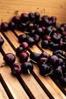 dark red ripe cherries in wooden bin photo