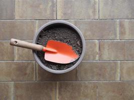 garden spade and earth bucket for potted plant photo