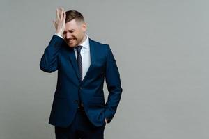 Depressed businessman in suit receiving bad news and feeling worried photo