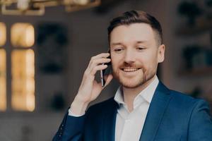 Young caucasian businessman making business call indoors photo
