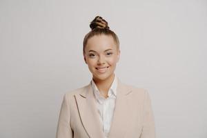 Happy attractive business woman in beige suit photo