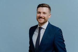 Portrait of successful businessman in suit smiling at camera photo