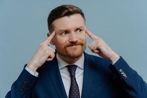 Angry upset businessman thinking about business problems, trying to find solution photo