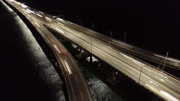 Flygfoto upptagen bil trafikljus spår över bron till havs video