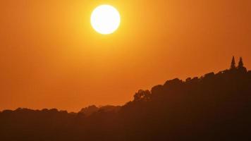 timelapse do pôr do sol dramático com céu laranja em um dia ensolarado.