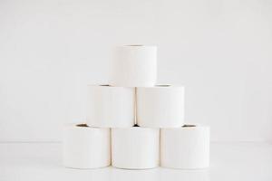 Rolls of white toilet paper on a white background photo