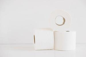 Rolls of white toilet paper on a white background photo