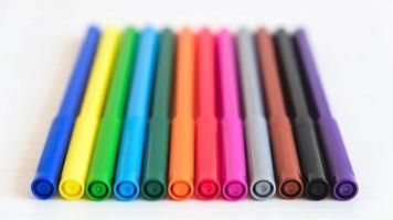 Multicolored felt-tip pens on a white background photo