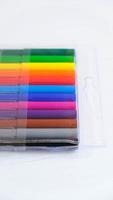 Colored felt-tip pens in a transparent package on a white background photo