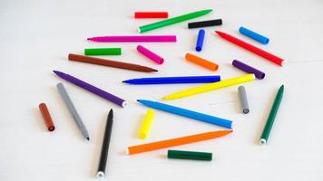 Multicolored felt-tip pens on a white background photo