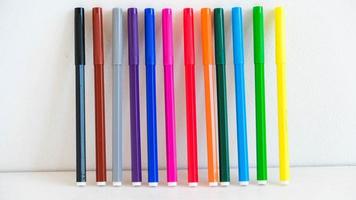 Multicolored felt-tip pens on a white background photo