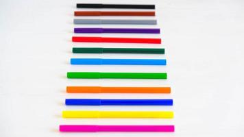 Multicolored felt-tip pens on a white background photo