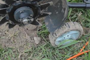 Hand cultivator for cultivation of a kitchen garden in the village photo