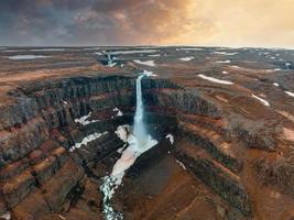 Aerial view on Hengifoss waterfall with red stripes sediments in Iceland. photo