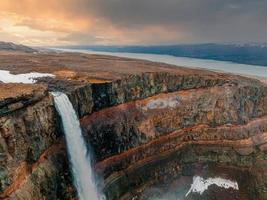 Aerial view on Hengifoss waterfall with red stripes sediments in Iceland. photo