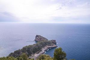 Beautiful view of Mediterranean sea and rocky cliff against cloudy sky in summer photo