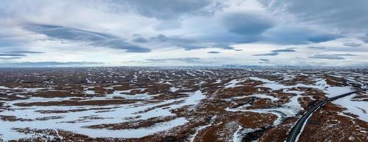 Aerial video of an empty lava fields and huge volcanic mountain in Iceland photo