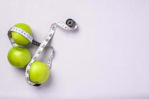 top view group of green apple with tape measure on pastel purple table photo