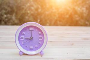 alarm clock with abstract nature bokeh blur background. photo