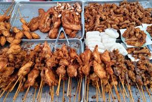 Fried chicken and sticky rice are sale in markets or street food. popular in Thailand photo