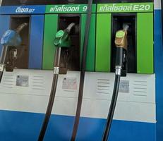 Bangkok, Thailand - May 16, 2022 Thai Petrol pump filling nozzles , Gas station photo