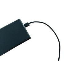 black power bank with USB cable isolated on white background photo