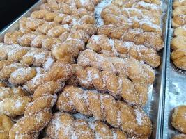Delicious twist sugar donuts on a tray photo