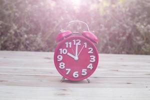 alarm clock with abstract nature bokeh blur background. photo