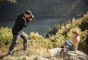 Beautiful woman smiling to her boyfriend camera while they traveling photo